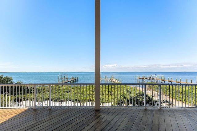 wooden terrace featuring a water view and a boat dock