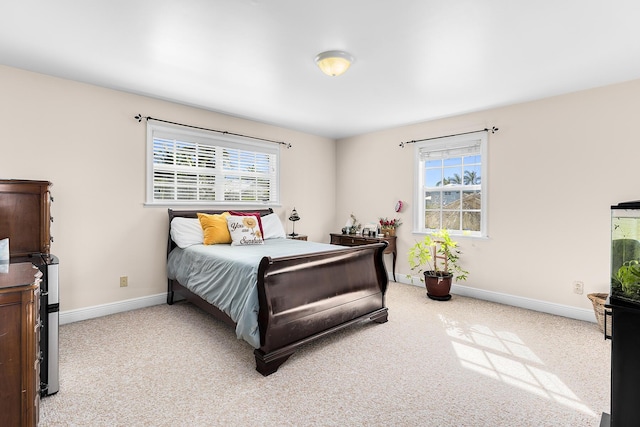 carpeted bedroom featuring multiple windows