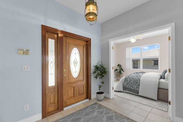 entrance foyer with baseboards and light tile patterned flooring