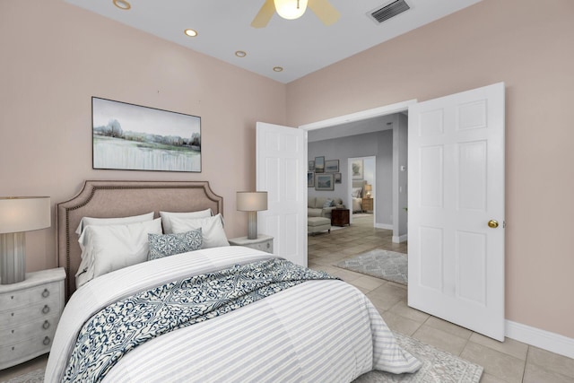 bedroom featuring baseboards, a ceiling fan, visible vents, and light tile patterned floors