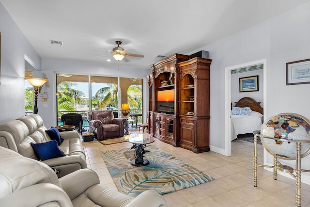 living room featuring light tile patterned floors and ceiling fan