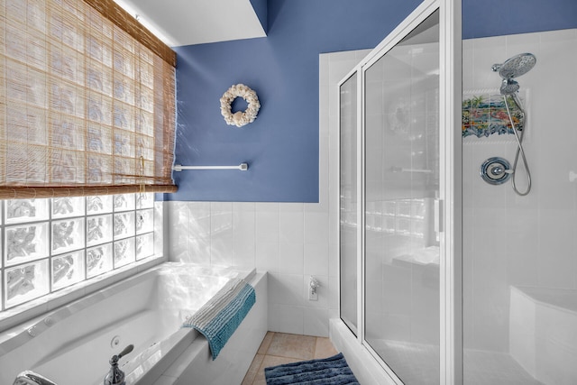 bathroom with tile walls, tile patterned floors, and plus walk in shower