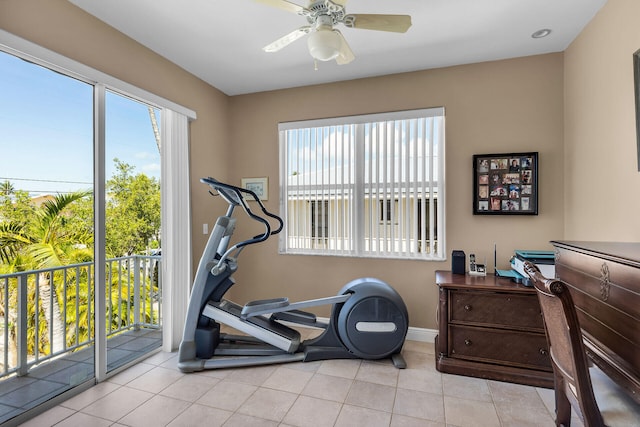 workout room featuring ceiling fan and light tile patterned flooring