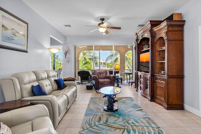 living room featuring light tile patterned floors and ceiling fan