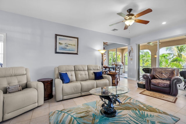 tiled living room featuring ceiling fan