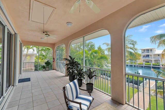 exterior space featuring tile patterned flooring and a water view