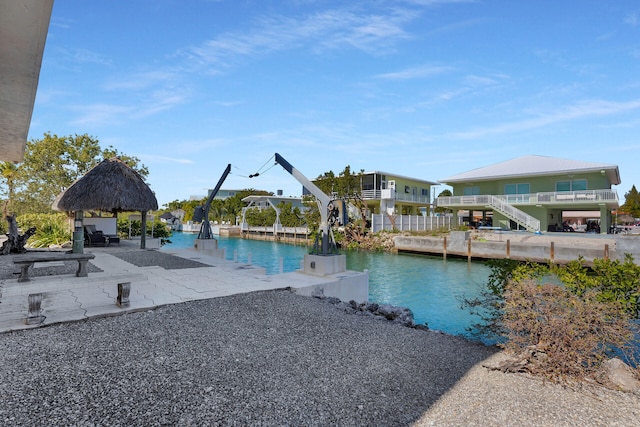 view of pool with a gazebo, a water view, and a patio