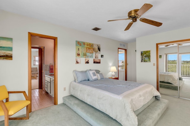 bedroom featuring carpet floors, access to outside, ceiling fan, and ensuite bath