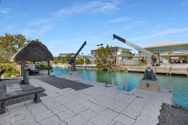 view of pool with a gazebo, a patio area, and a water view