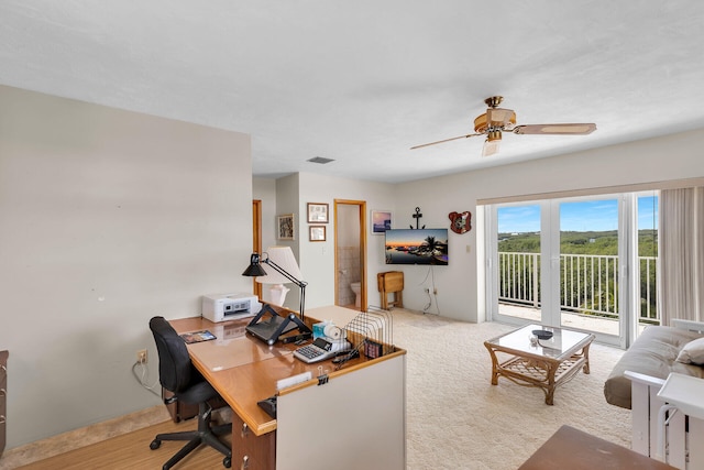 carpeted office with ceiling fan