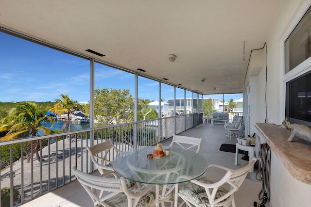 interior space featuring a balcony and a water view