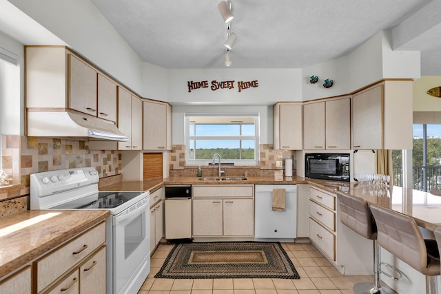 kitchen featuring sink, white appliances, light tile patterned flooring, light brown cabinetry, and decorative backsplash