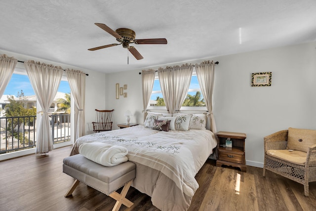 bedroom with dark wood-type flooring, ceiling fan, and access to exterior