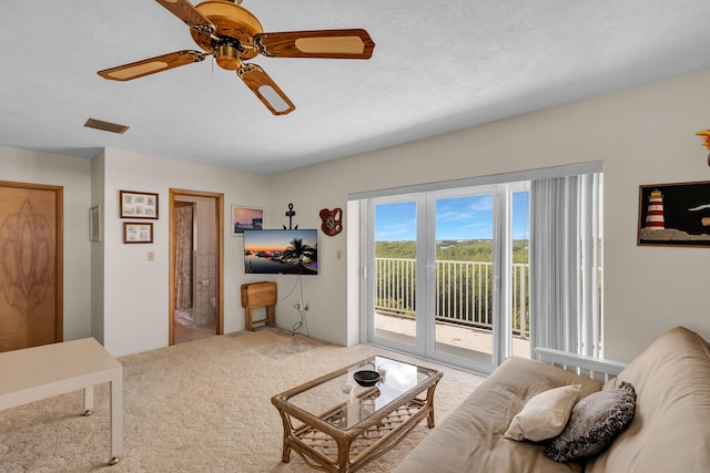 carpeted living room featuring ceiling fan