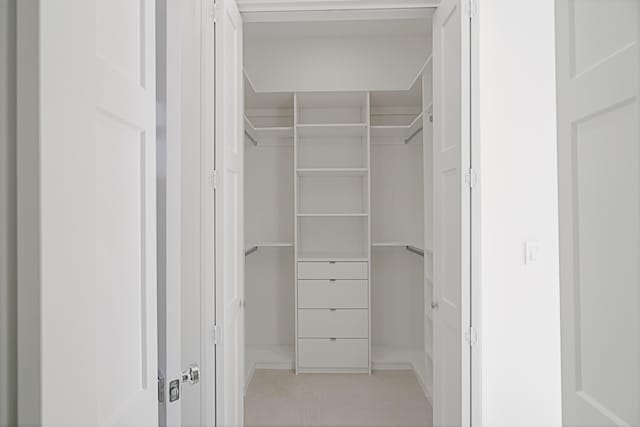 spacious closet with light tile patterned floors