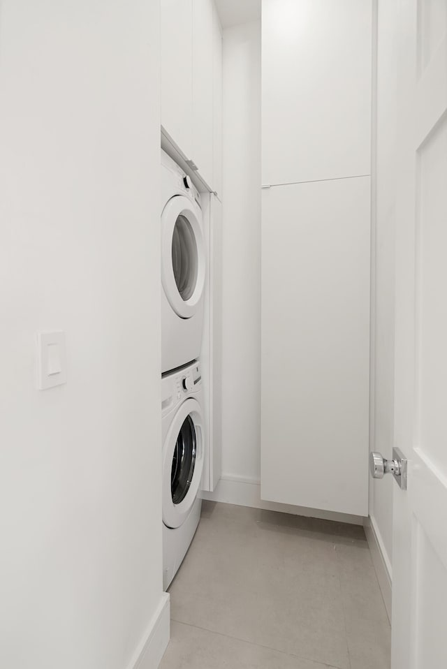 clothes washing area with stacked washer and clothes dryer