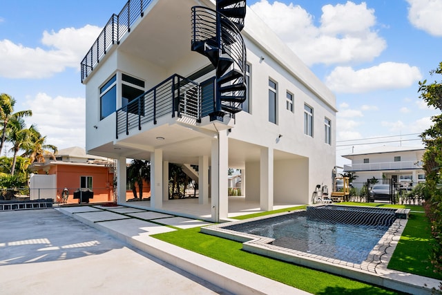 back of property with a patio area and a balcony