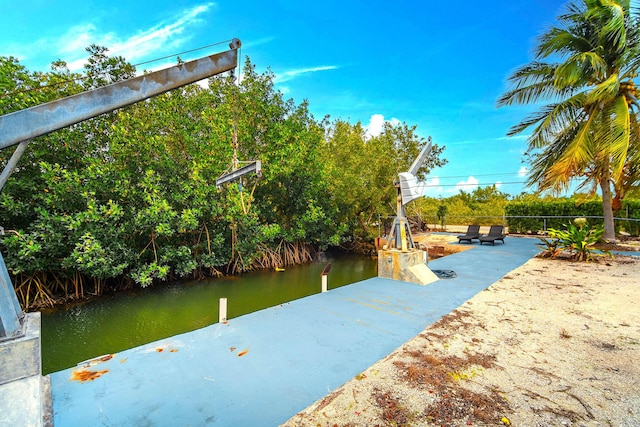 exterior space featuring a water view and a boat dock