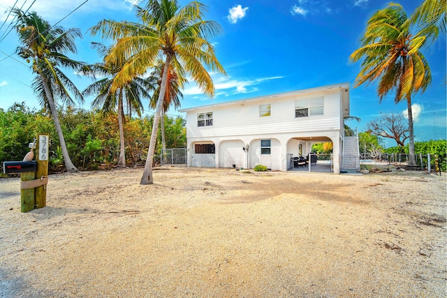 view of front of property with a carport and dirt driveway