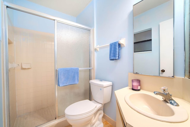 full bathroom featuring a shower stall, toilet, and vanity