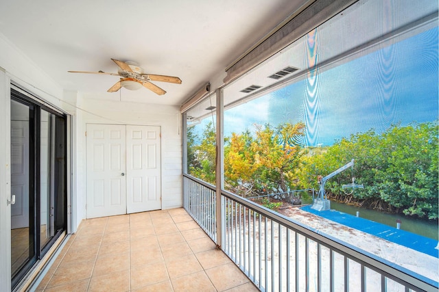 unfurnished sunroom with a ceiling fan