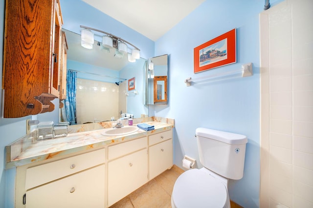 bathroom with toilet, tile patterned floors, a tile shower, and vanity