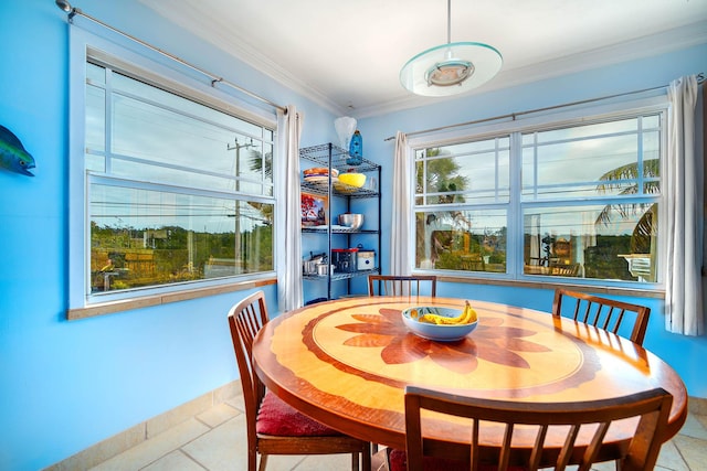 dining space with crown molding, baseboards, and light tile patterned floors