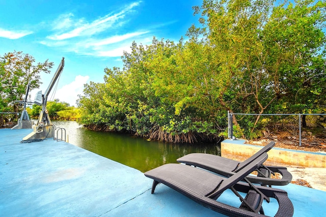 view of patio featuring a water view and a boat dock