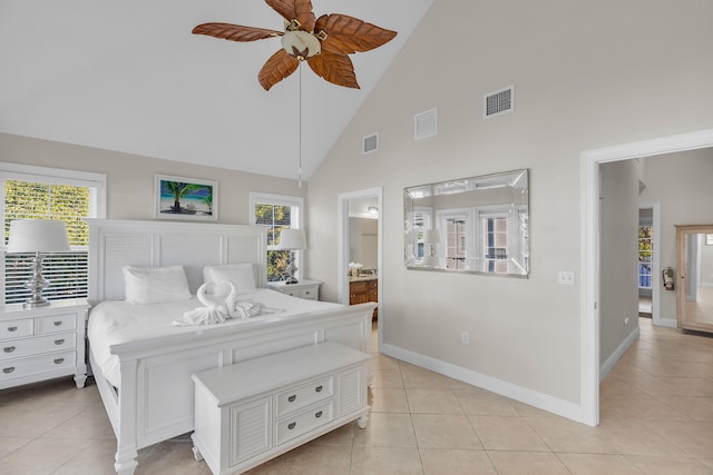 tiled bedroom featuring multiple windows, ensuite bathroom, ceiling fan, and high vaulted ceiling