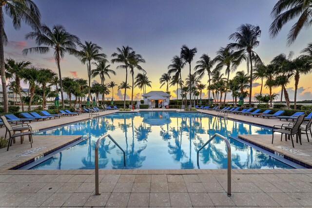 pool at dusk with a patio