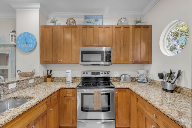 kitchen featuring crown molding, appliances with stainless steel finishes, sink, and light stone counters