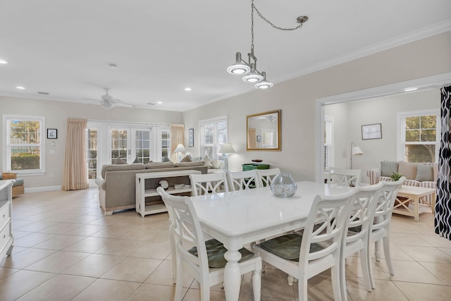 dining space with crown molding, light tile patterned floors, and ceiling fan