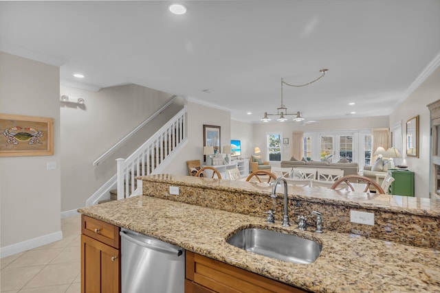 kitchen featuring sink, light stone counters, light tile patterned floors, ornamental molding, and dishwasher