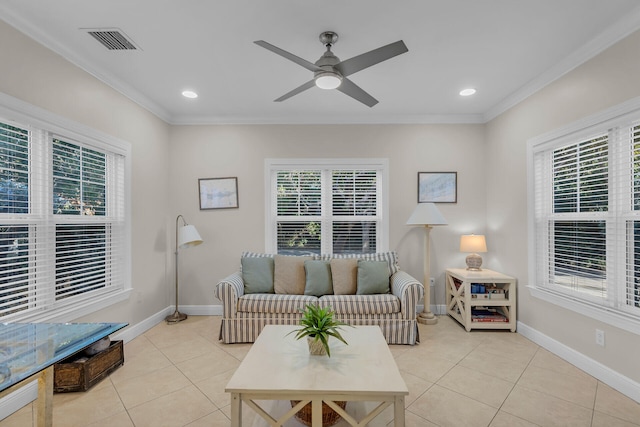 tiled living room with ceiling fan, a healthy amount of sunlight, and ornamental molding