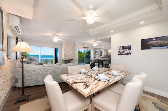 dining space featuring a water view, dark hardwood / wood-style floors, a wall mounted air conditioner, and crown molding