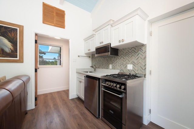 kitchen featuring sink, decorative backsplash, stainless steel appliances, and white cabinets