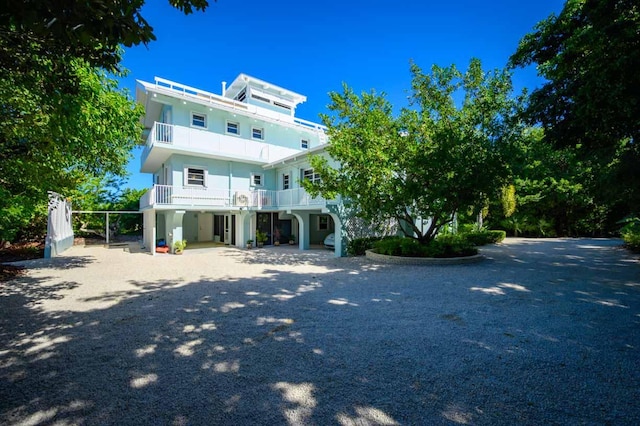 view of front of property featuring a carport and a balcony