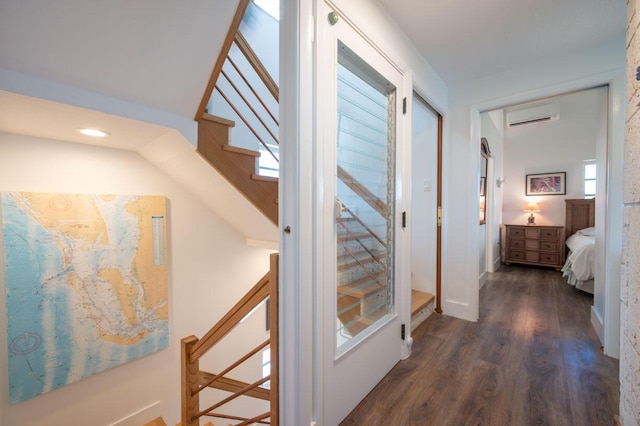 hallway featuring a wall mounted AC and dark hardwood / wood-style flooring