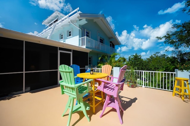 view of patio with a sunroom