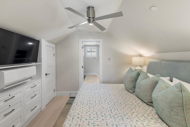 bedroom with ceiling fan, lofted ceiling, and light wood-type flooring