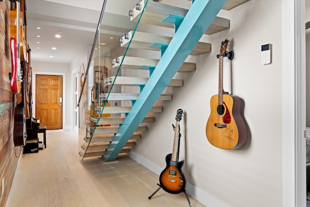 stairs with hardwood / wood-style flooring