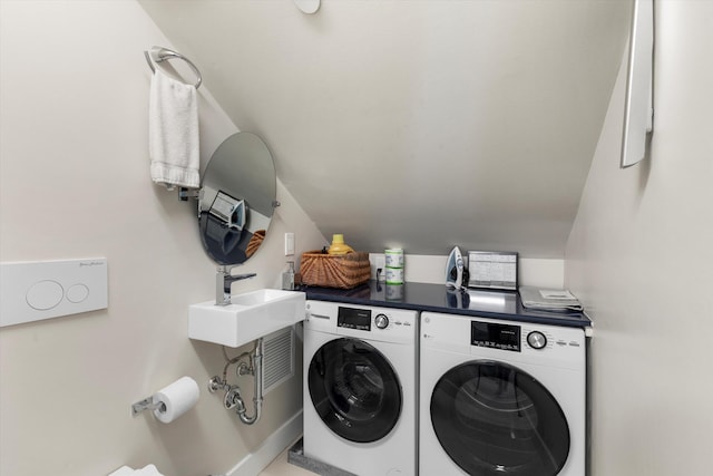 washroom with sink and washer and dryer