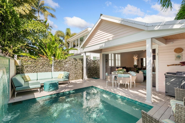 view of pool featuring an outdoor living space and a deck