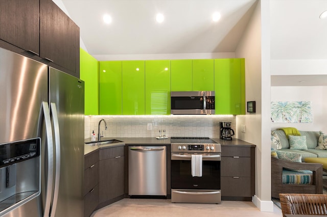 kitchen with appliances with stainless steel finishes, sink, and decorative backsplash