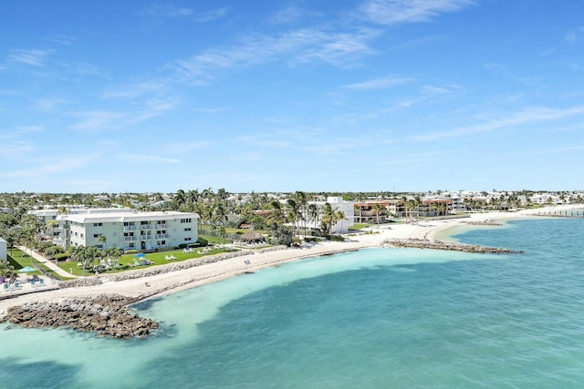 birds eye view of property with a water view and a view of the beach