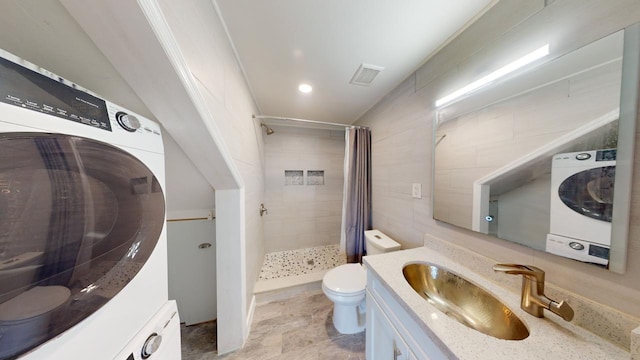 bathroom with washer / clothes dryer, vanity, and walk in shower