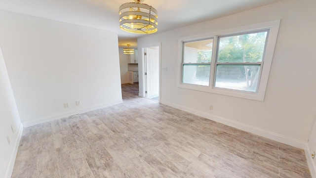 empty room with light hardwood / wood-style flooring