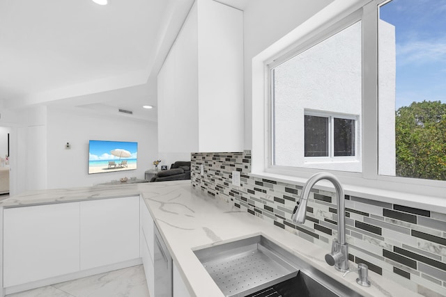 21 Lakeview Dr, Key Largo, FL 33037 - kitchen with a sink, white cabinets, light stone countertops, backsplash, and modern cabinets