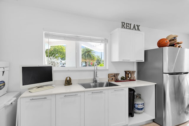 21 Lakeview Dr, Key Largo, FL 33037 - kitchen with a sink, freestanding refrigerator, white cabinetry, and light countertops