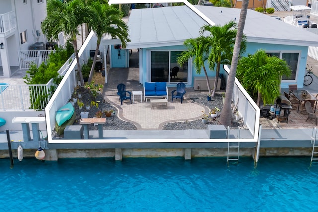 rear view of property with an outdoor fire pit and a patio area